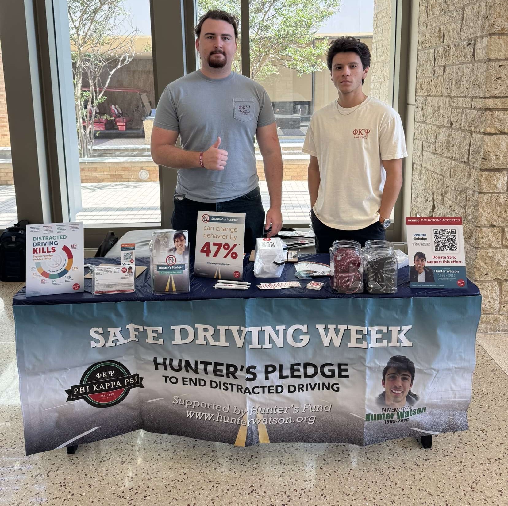 Picture of Two Handsome Active Members of Phi Psi Tabling for Hunter's Fund