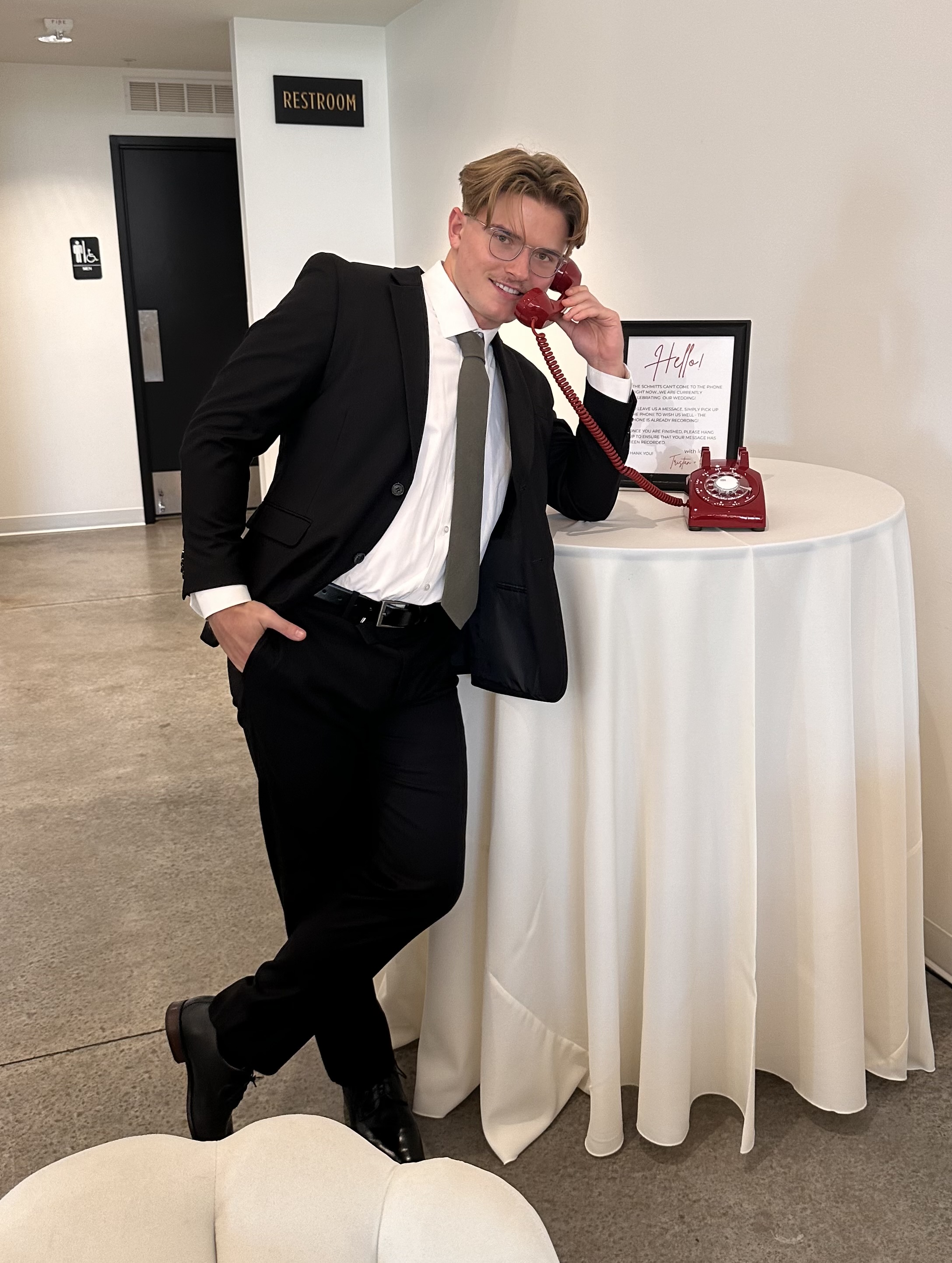 A handsome man (Sten Schmidt) wearing a tux while talking on the phone